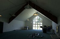 Looking into the room above the garage, with its windows looking out towards the main house and the ocean.   