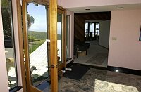 The small room connecting the foyer to the main living room.  The current owners use this as the TV room.  .  