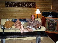 Finally esconced in our villa at Turtle Inn, Placencia, Belize, Doug relaxes in the living room after dinner.  