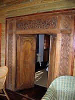 Detail of the entrance to one of the bedrooms at Turtle Inn.  These doorways appear to be Balinese antiques, with very old metal hinges and elaborate wood carving.  