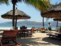 Beach attendants and waiters bring food and drinks all day.  Just raise the flag on your palapa and they're there to take your order!  